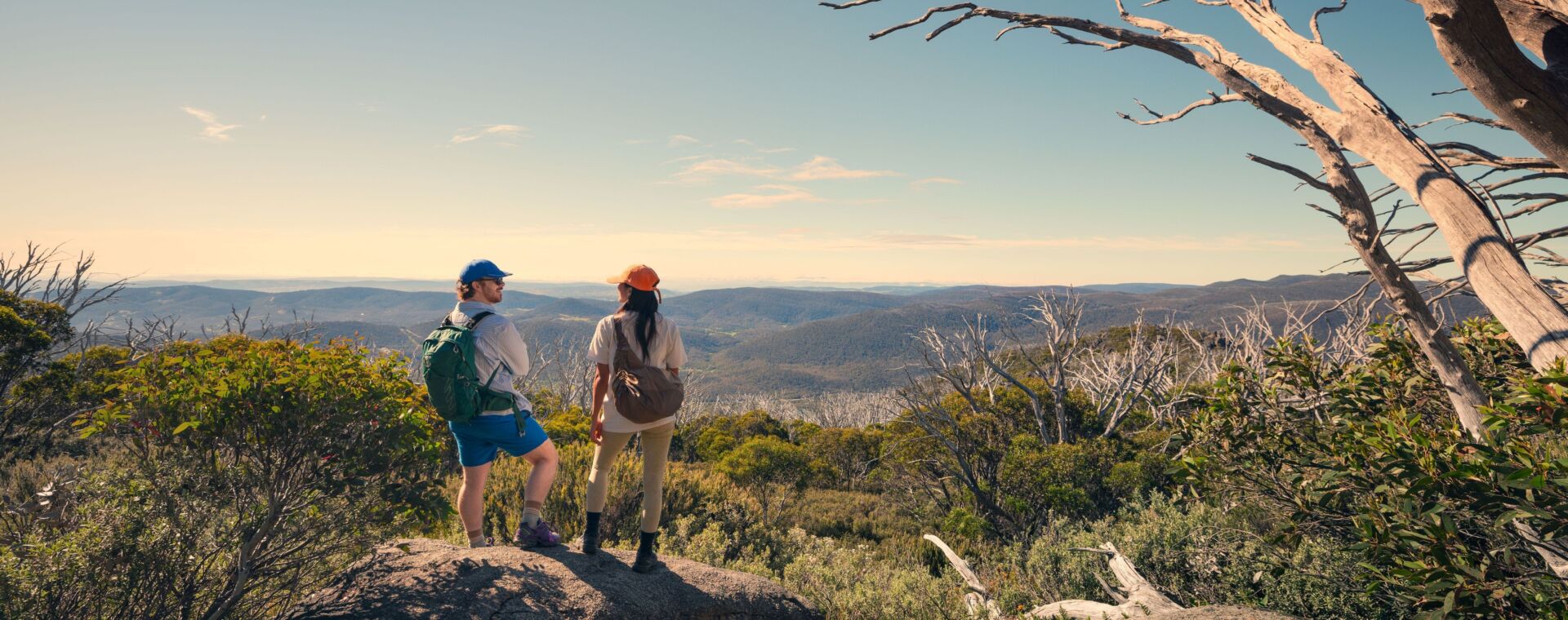 A couple takes in the amazing views during a hike along the Snowies Alpine Walk, - Perisher to Bullocks Flat, Snowy Mountains, Snowy Mountains