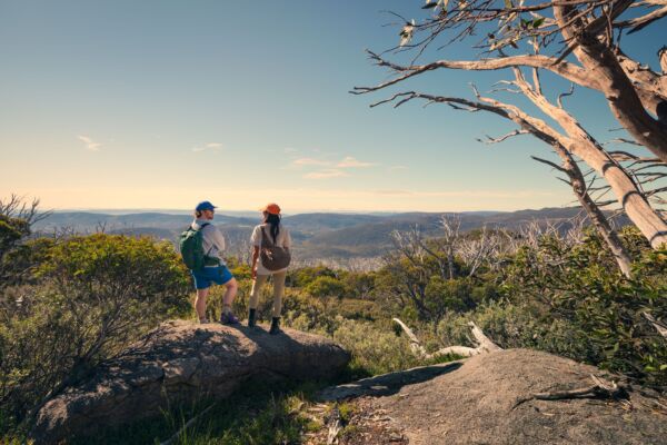A couple takes in the amazing views during a hike along the Snowies Alpine Walk, - Perisher to Bullocks Flat, Snowy Mountains, Snowy Mountains