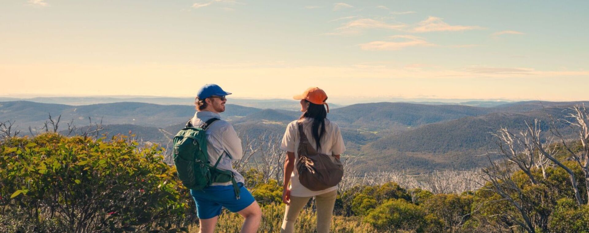 A couple takes in the amazing views during a hike along the Snowies Alpine Walk, - Perisher to Bullocks Flat, Snowy Mountains, Snowy Mountains